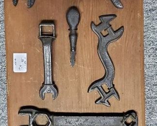 Antique tools mounted to decorative board for display
