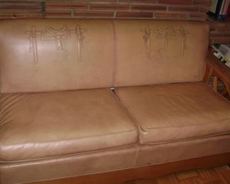 1950'S TAN NAUGA HYDE WAGON WHEEL COUCH THAT TURNS INTO A SLEEPER SOFA--EMBOSSED SADDLES