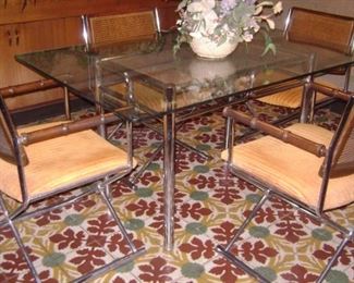 MID CENTURY-1970'S CHROME TABLE SET---NICE THICK GLASS RECTANGULAR TOP WITH A CANE INSERT MIDDLE--4 CHROME SQUARE CHAIRS WITH CANE BACKS