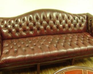 NICE MAHOGANY RED TUFTED LEATHER COUCH---BRASS STUDDED AND IN GOOD SHAPE--NO RIPS OR HOLES
