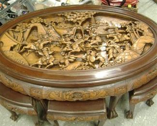 FROM WW11 ---ROSEWOOD--HIGHLY CARVED AND INTRICATE FIGHTING WARRIORS--HAND CARVED CHINESE TEA TABLE WITH CARVED STOOLS THAT FIT UNDER THE TABLE--HAS A OVAL GLASS TOP THAT WE TOOK OFF FOR THE PICS.-