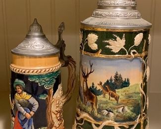 Item 320:  Steins, one is green with reindeer: $75                           Tallest - 9.5"
