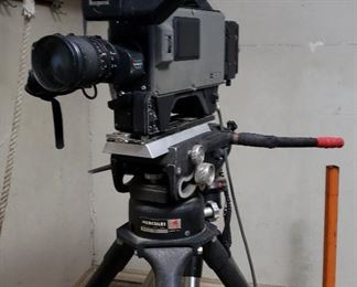 Authentic movie camera and rolling tripod