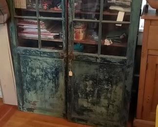 antique cupboard shown with glass doors