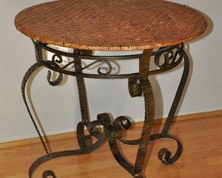 24" ROUND SCROLL BLACK METAL AND HERRINGBONE WICKER SIDE TABLE. 24.5"H. OUR PRICE $125.00
