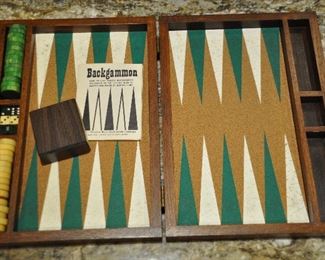 VINTAGE DRUEKE BLUE CHIP GAME CO., MADE IN MICHIGAN. WOOD BACKGAMMON GAME SET WITH CORK BOARD, 30 BAKELITE GREEN AND BUTTERSCOTCH CHECKERS, ONE BOX, 5 DICE IN VERY GOOD CONDITION. CLOSED 15"W X 10 5/8H X 2"D. OUR PRICE $150.00