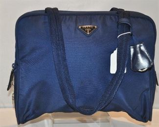 PRICE REDUCED!!  AUTHENTIC PRADA NAVY LARGE NYLON TOTE BAG WITH CANVAS STRAP AND LOCK AND KEY, IN EXCELLENT CONDITION (INCLUDES DUST BAG), 12" X 9". OUR PRICE $195.00 
