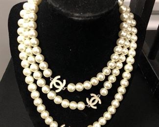 52” FAUX PEARLS WITH ENAMEL CHANEL LOGO. OUR PRICE $110.00