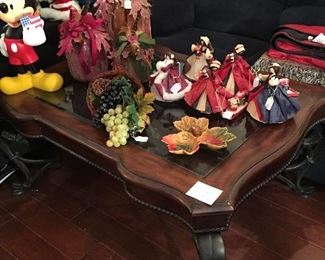 Nice wood & glass coffee table, corn husk dolls & autumn decorations. Also another Mickey Mouse statue. 