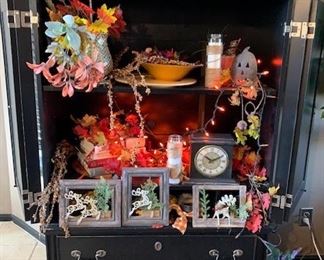 Beautiful, black armoire with holes in back for TV cables.