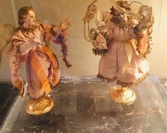 pair of 18th century angel figures in a Lucite display case