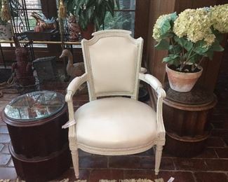 needlepoint topped small tables and fine leather chairs