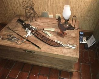 low 19th century oak chest with many primitives including sword and spurs