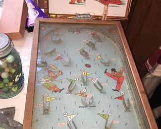 early pinball game that involves sporting scenes