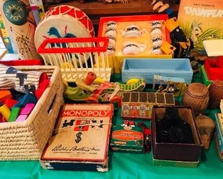 taable filled with old games and wooden toys