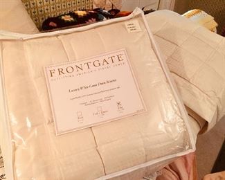 Stacks of luxurious bed coverings.