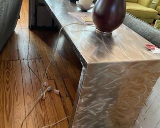 The steel table was made to fit between the couches. It's 7' long 