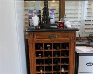 Wine rack with black composition "marble" top. Wine not available.