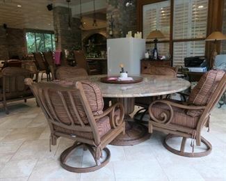Beautiful indoor or outdoor dining set with swivel reclining chairs. $750. Table 90" diameter. Powder finish chairs in cafe ole color. Sunbrella fabric.