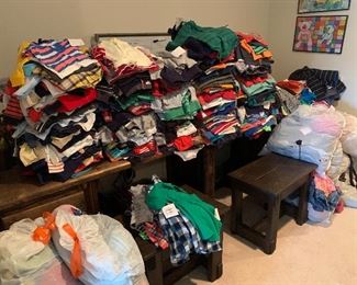 Piles of boys shirts categorized by size  