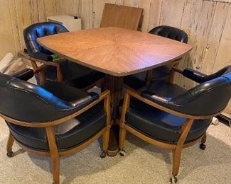 The Schoonbeck Co. Card table with leaf.  36”W x 29”H. Leaf is 20”W. Four black leather and wood tufted roller Captain’s chairs. 25”W x 29.5”H x 23”D. BIN set $100