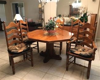 50" custom built, solid wood octagon pedestal table with two 12" leaves and full table padding, 2 arm chairs and 4 side chairs. $400                                                                                        The table, chairs and matching hutch are $600.