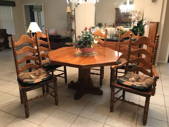 50" custom built, solid wood octagon pedestal table with two 12" leaves and full table padding, 2 arm chairs and 4 side chairs. $400                                                                                        The table, chairs and matching hutch are $600.