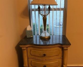Our apologies for the lighting here, but the two nightstands match the armoire and long dresser. Same black specked marble top as the long dresser. *Note: the top knob needs to be re-attached.