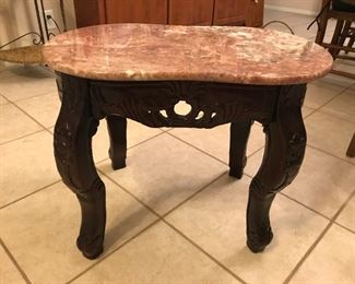 Coral marble top table with carved wood base. $65