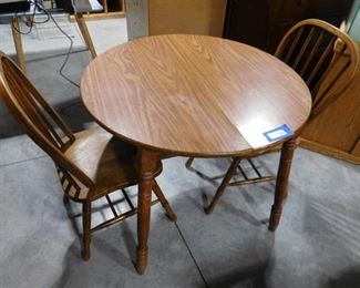 Small dinning table with 2 matching chairs 29in H X 36in dia. ( some water damage )