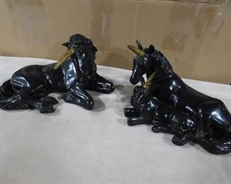 Black unicorn statues with gold horns