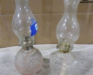 2 oil lamps with designs on glass body