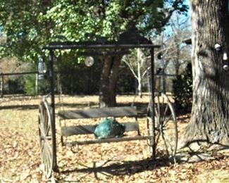 Custom made outdoor swing.  Made to look like old time buggy.  Cute oversize frog is taking a ride! :)