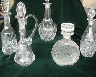 Large collection of cut glass decanters