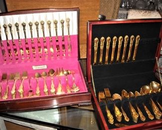 Three large sets of gold flatware including many serving pieces