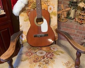 Guitar on antique arm chair