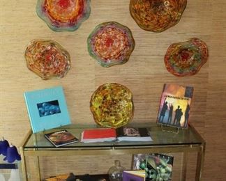 Handblown glass wall art with books on glass blowing, art and Chihuly.