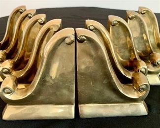 $28/PAIR. Five sets of brass scroll bookends. Measures 6” tall.