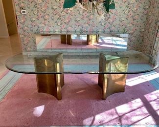 $3200. Gorgeous, modern, oval, glass top dinning table with brass pedestals. Table measures 100x48x28. Seats 8 comfortably. This classic design still sells new for much more! :)