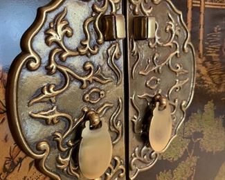 Close up picture of brass hardware on Chinoiserie Cabinet.