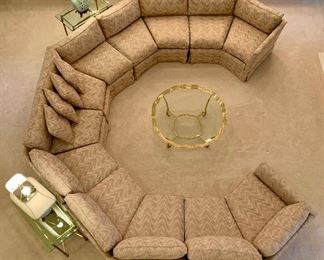 Alternate view! Custom, 6 piece circular sectional sofa, by Jack Brandt. Sofa is beige with accents of blue, mauve and light pink. Approximate measurements: left arm 70 inches, center arm 140 inches and right arm 70 inches. Excellent condition.