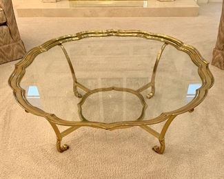 $300. Glass top coffee table with scalloped brass base. Table is 42 inches in diameter and is 16 inches in height. Excellent condition.