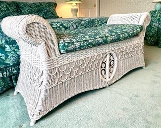 Close up of the white wicker sleigh bench.