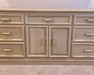 $250. Full size vintage dresser by Broyhill. Color is a pale pink wood with brass accents on the hardware. 66" L.