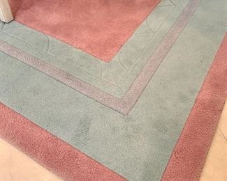 Close up of the pink and teal area rug.