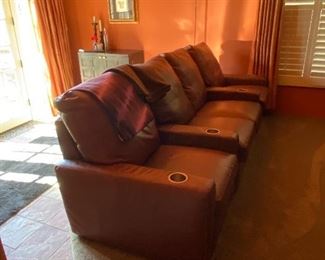 Two rows of leather reclining home theatre seats