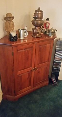 Corner cabinet with collectibles atop