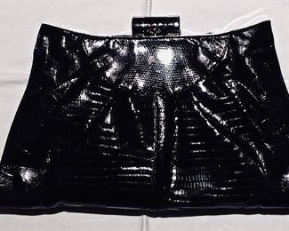 Black lizard skins clutch. Skins disconnecting from metal top on one side. Otherwise, very good condition.
