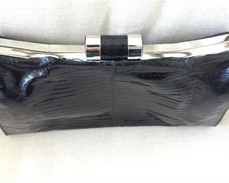 Black lizard skins clutch. Skins disconnecting from metal top on one side. Otherwise, very good condition.