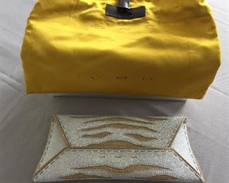 GOLD AND SILVER SPARKLY GLITTER CLUTCH
Condition: Pristine
Grey suede lining. Single wall pocket at interior. Fold-in flap closure at front flap
Dimensions: Width: 12". Height: 5"